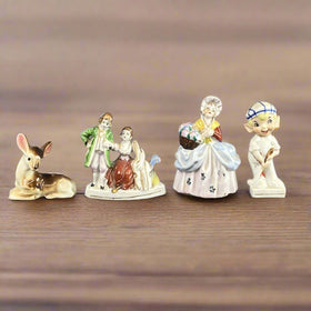 Lot of 4 Occupied Japan Figurines Deer, Couple, Girl with Basket, Golfer