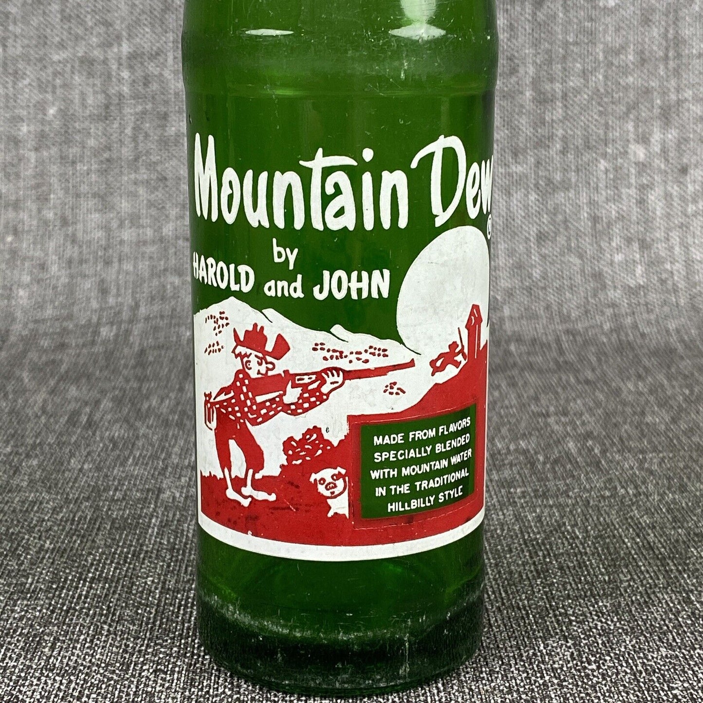 Vintage Mountain Dew 10 oz. Bottle by Harold and John Bottle- Has Flea Bite