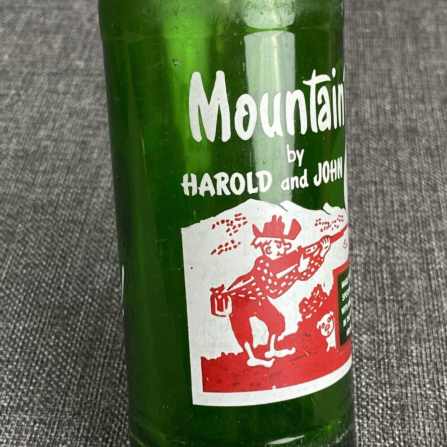 Vintage Mountain Dew 10 oz. Bottle by Harold and John Bottle- Has Flea Bite