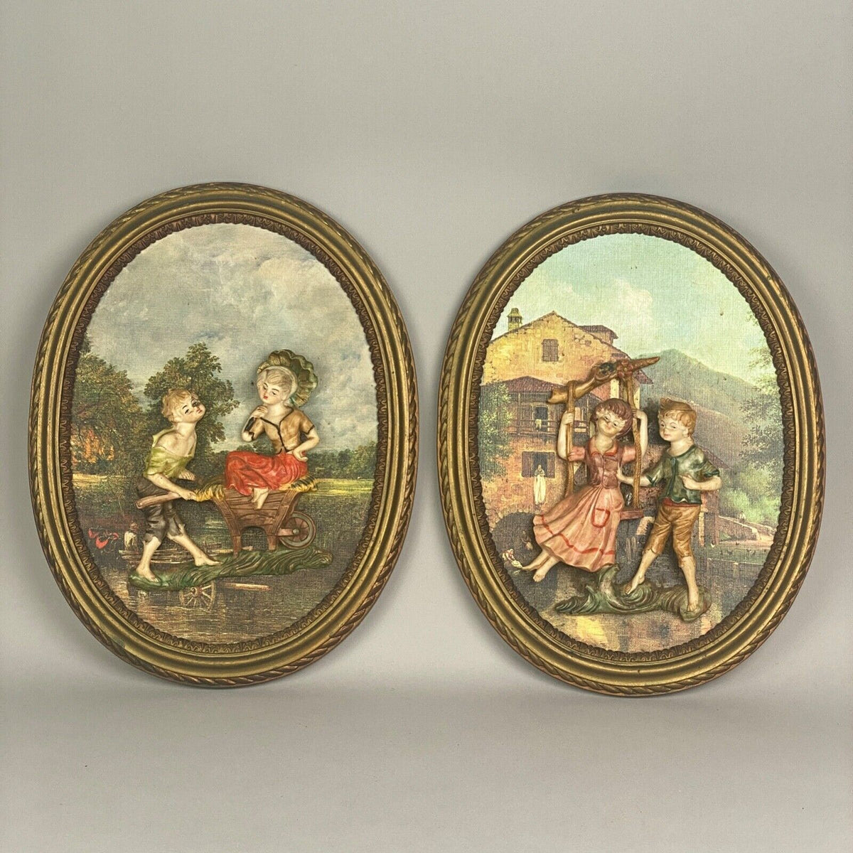 Pair of Boy and Girl Depose Italy 3D Figures Situated in an Oval Frames 16"x12"